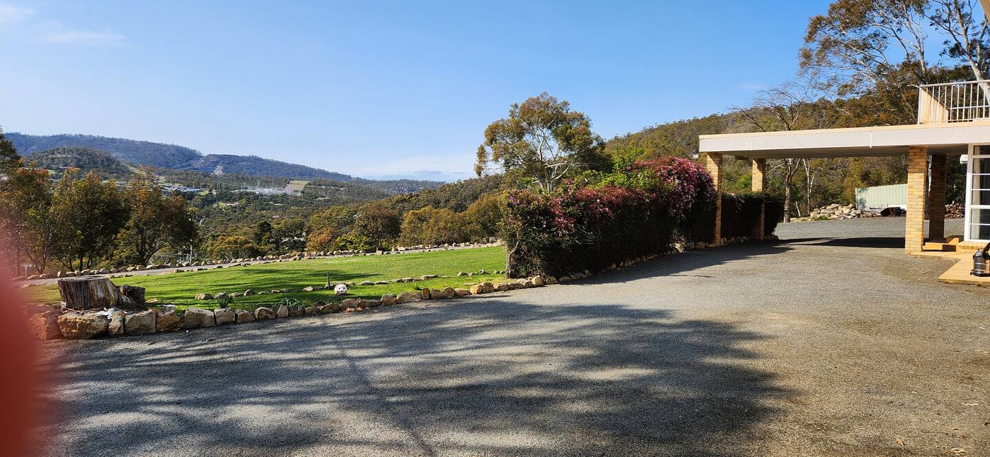 Front yard and driveway with a distant view